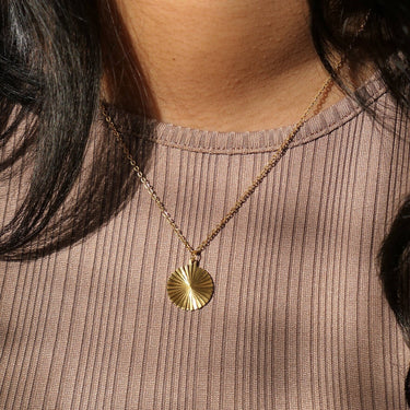 Circle sunburst necklace on model