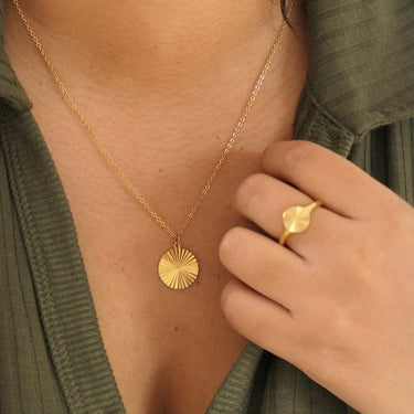 Circle sunburst necklace on model with matching sunburst ring - entirely waterproof and tarnish resistant