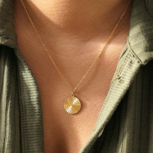 Circle sunburst pendant necklace on a model